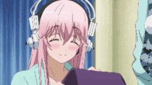 a girl with pink hair is wearing headphones and smiling with her eyes closed