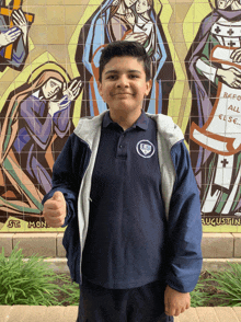 a boy in front of a mural that says st. mon