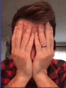 a man covering his face with his hands with the name chris cubba visible