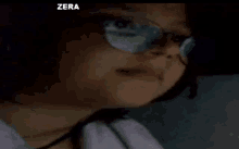 a close up of a person 's face with the word zera visible