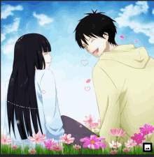 a boy and a girl sit in a field of pink flowers