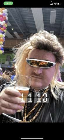 a man wearing sunglasses and a wig holds a glass of beer in front of a clock that reads 11:13