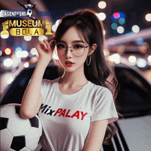 a girl wearing a white shirt that says mix palay holding a soccer ball