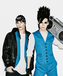 two men standing next to each other with one holding a boombox that says sony