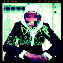 a man wearing a hooded jacket and a white scarf has the word omauq written in green