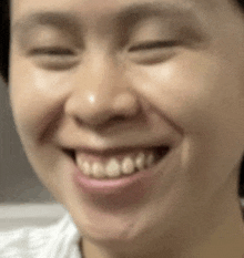 a close up of a woman 's face with a smile on her face .