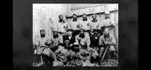 a black and white photo of a baseball team posing for a team photo .