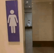 a purple sign with a woman 's figure on it