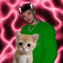 a man in a green sweater holds a cat