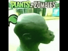 a man with a shaved head and a green leaf on his head is wearing a plants vs zombies shirt .