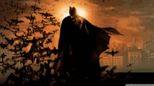 batman is surrounded by a flock of bats and a city in the background