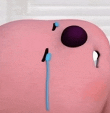 a close up of a pink piggy bank with a blue stick sticking out of it