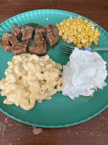 a green plate with macaroni cheese corn and mashed potatoes