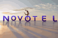 a person is jumping in the air in front of the word novotel