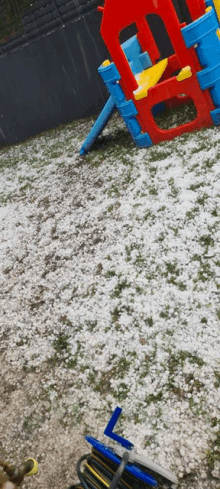 a playground with a lot of hail on the grass