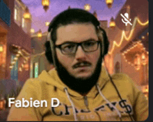 a man wearing headphones and a yellow hoodie with the name fabien d