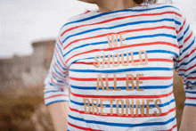 a woman wearing a striped shirt that says " we should all be bretonnes "