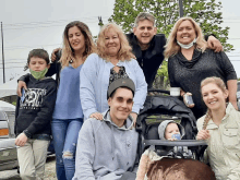 a group of people posing for a picture with a boy wearing a sweatshirt that says ' abercrombie & fitch '