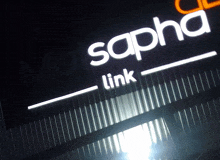 a sign that says sapha link is lit up in the dark