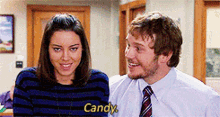 a man and a woman are standing next to each other and the woman says " candy "