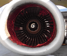 a close up of an airplane engine with a swirl in the center