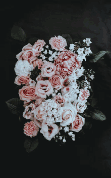 a bunch of pink flowers on a black background