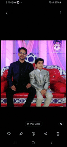 a man and a boy are posing for a picture on a couch ..