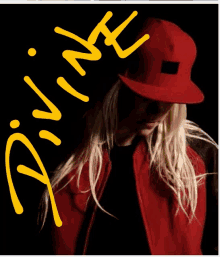 a woman wearing a red hat and a red jacket has divine written in yellow