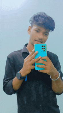 a young man taking a picture of himself with his cell phone