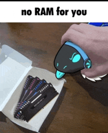 a box of ram is on a table with a cartoon character that says " no ram for you "