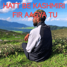 a man sitting in the grass with the words hatt be kashmiri fir aagya tu written above him