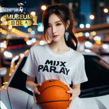 a woman in a white shirt that says mix paray holds a basketball in front of a car