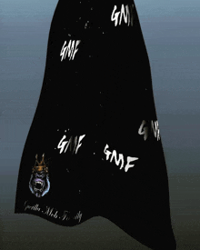 a black cape with gmf written on it and a gorilla on it