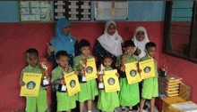 a group of children are posing for a picture with their teacher and holding awards