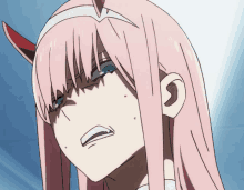 a girl with pink hair and horns is making a funny face