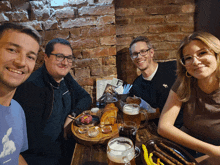 a group of people are sitting at a table with a menu on it