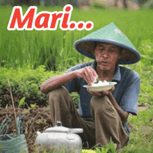 a man wearing a conical hat is sitting in the grass holding a plate of food with the word mari above him