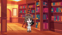 kat-chan is standing in a library holding a heart with the letter s on it