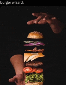 a person is holding a hamburger with the ingredients falling out of it and the caption burger wizard