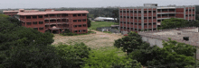 a large building with a lot of windows is surrounded by lots of trees