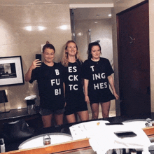 three women wearing black t-shirts that say bes fu ck tc bi t ing hes