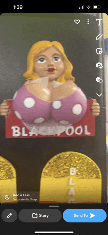 a phone screen shows a picture of a woman holding a blackpool sign