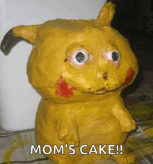 a statue of a pikachu that says mom 's cake on it