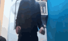 a blurry picture of a person standing in front of a book shelf