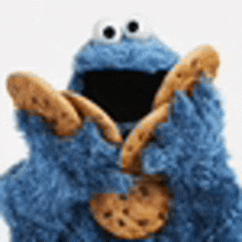 cookie monster from sesame street is holding a cookie with his mouth open .