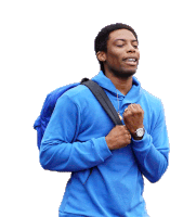 a man wearing a blue hoodie is carrying a backpack