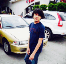 a boy stands in front of a kfc store