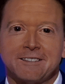 a close up of a man 's face with black eyes