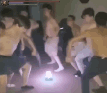 a group of people are dancing in a room with a light coming out of the floor .