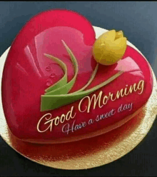 a heart shaped cake with a yellow flower and the words `` good morning have a sweet day '' on it .